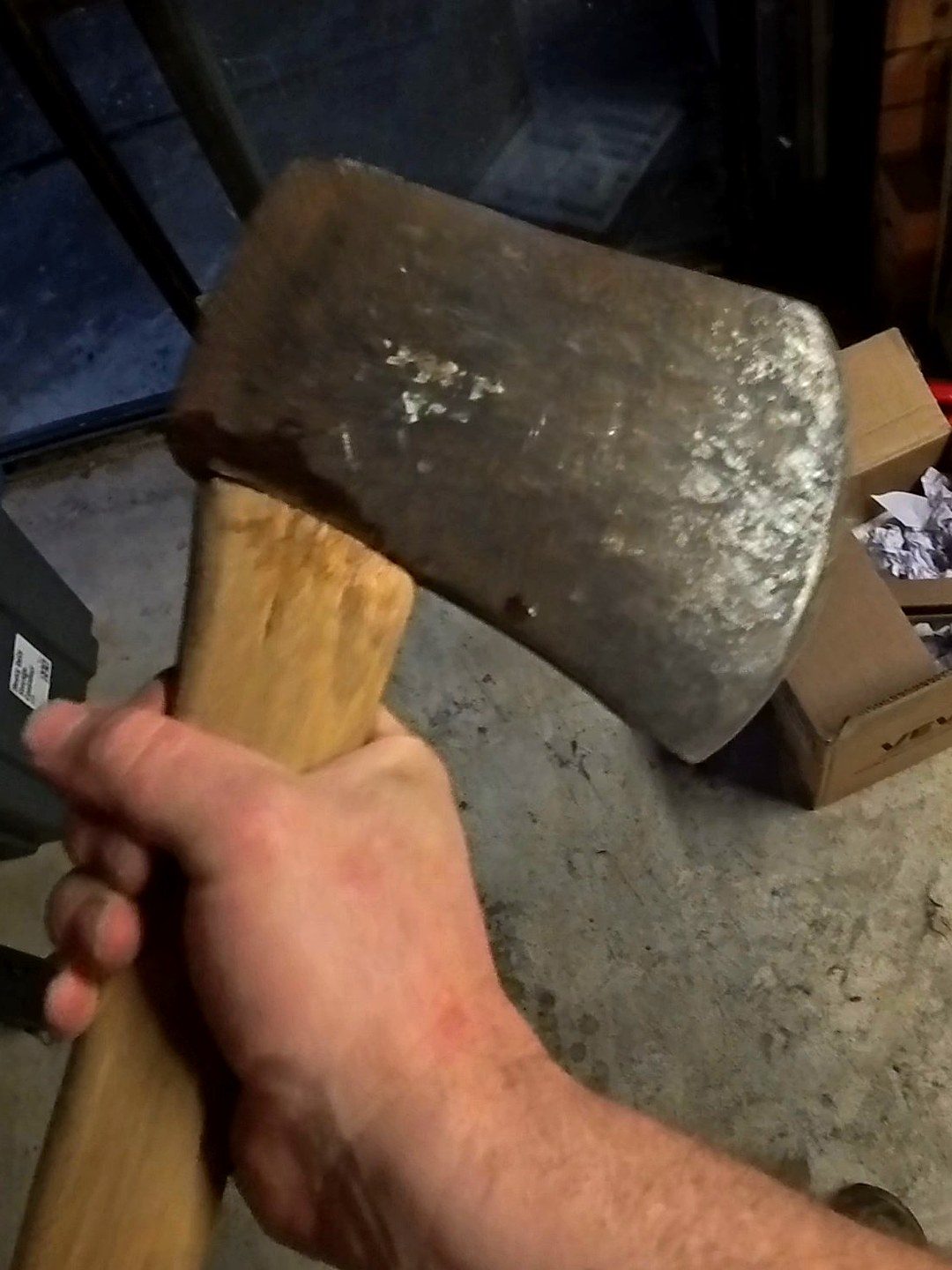 Rusted axe head before restoration, pitted and scaled