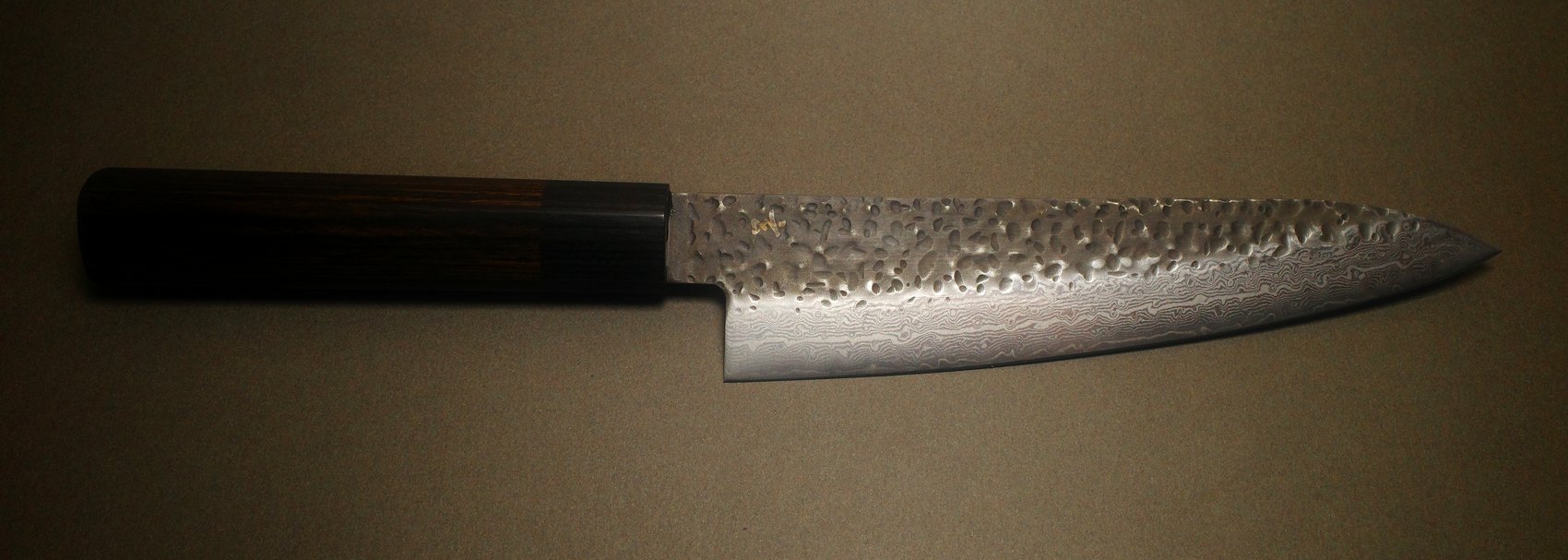The same damascus gyuto after sharpening, pattern and edge restored
