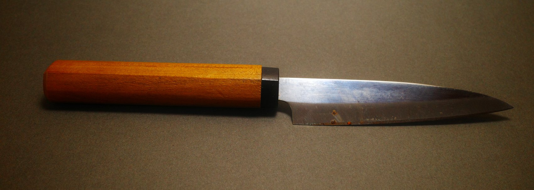 Japanese petty knife before sharpening, showing rust spotting along the blade