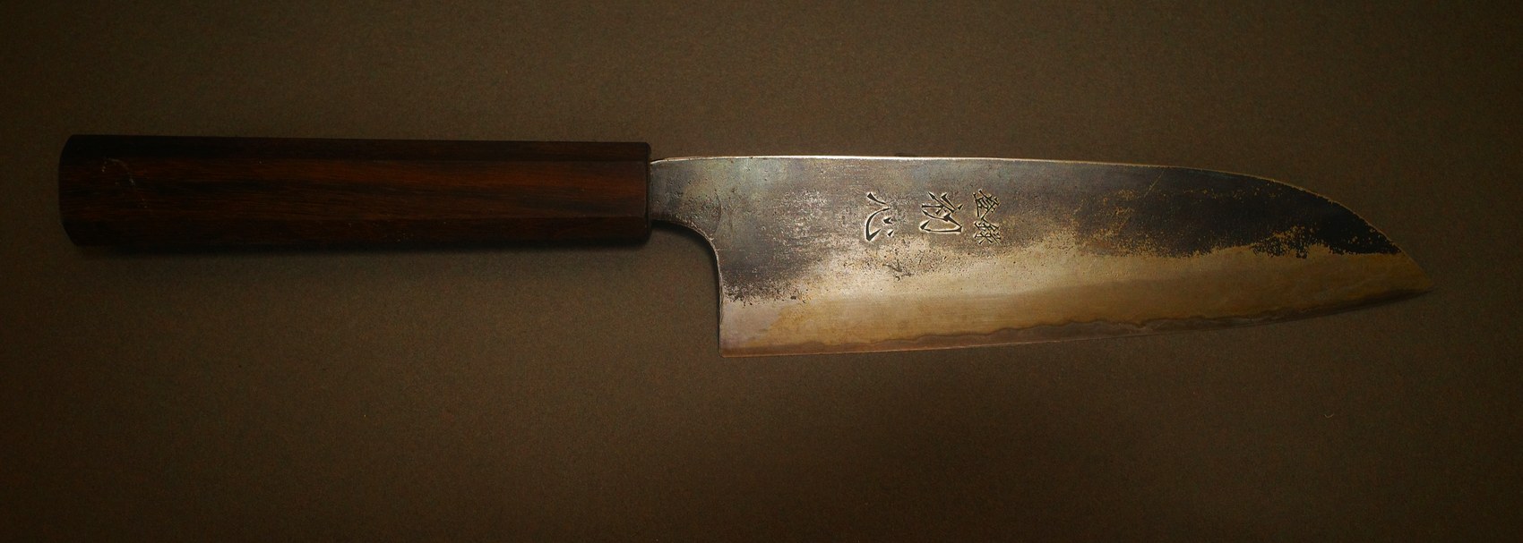 Japanese carbon steel knife before sharpening, edge dulled and blade discoloured