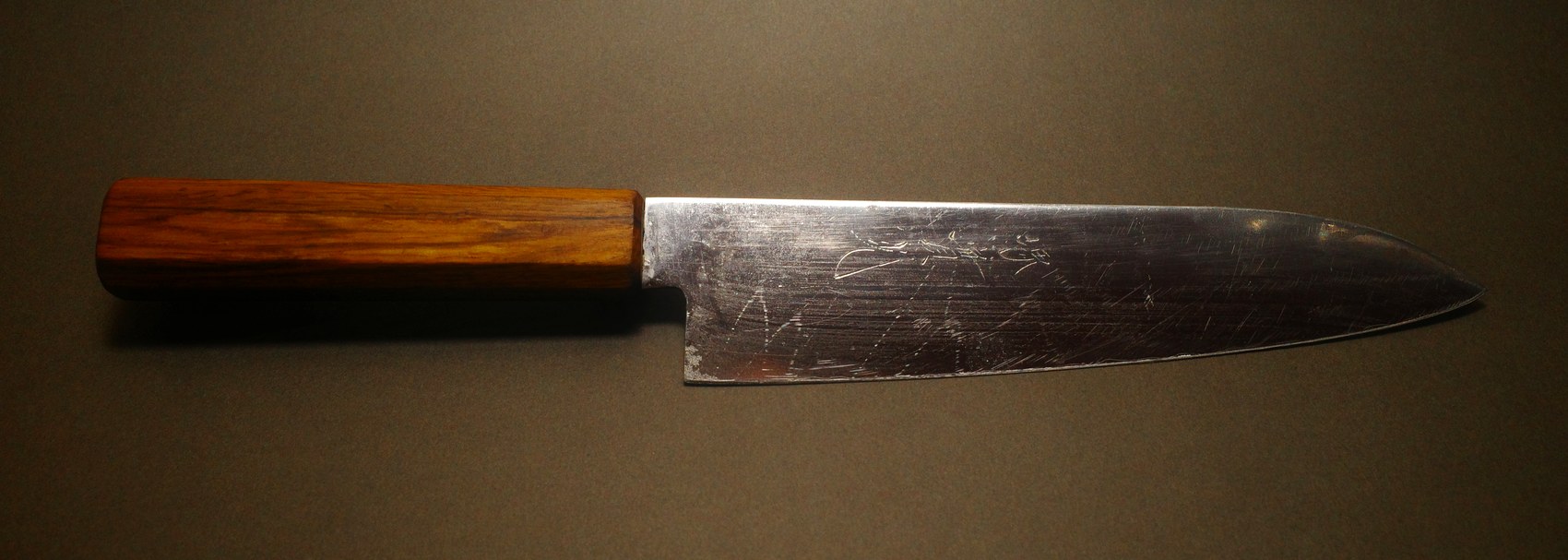 Wooden handled Japanese chef knife before sharpening, showing years of use