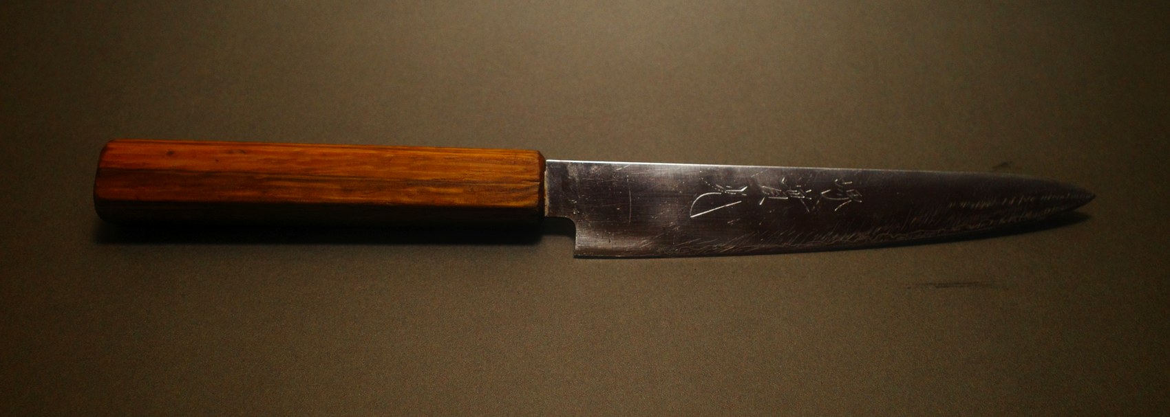 Small Japanese petty knife before sharpening, blade darkened and worn