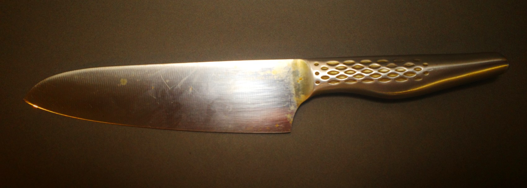 KAI chef knife before repair, blade stained and the tip blunted
